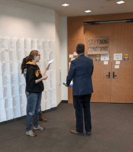 FFUW member talks to an attendee of the UW board meeting.